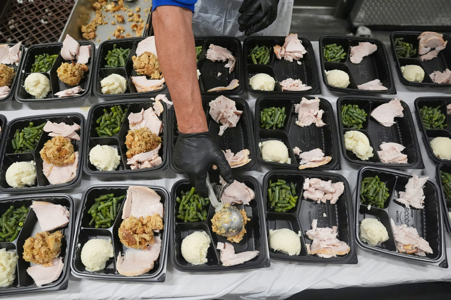 A volunteer prepares meals at the Philabundance Community Kitchen in Philadelphia, Thursday, Oct. 3...