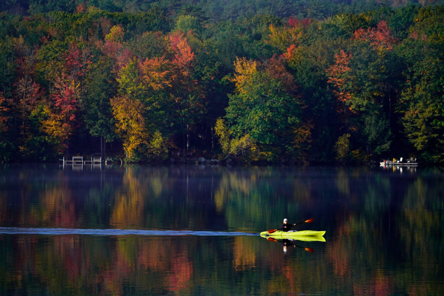 FILE - Virginia Davidson of Bridgton, Maine, paddles her kayak on Moose Pond, Oct. 13, 2021, in Bri...