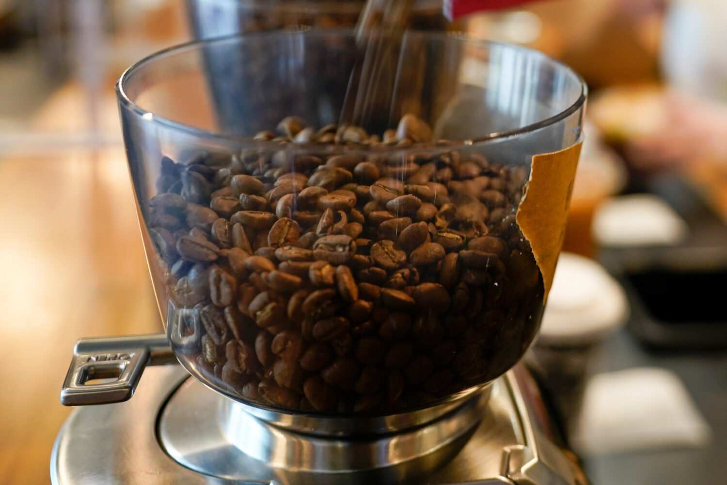 FILE - Coffee beans are poured into a grinder at a cafe in College Park, Md., on Wednesday, Sept. 1...