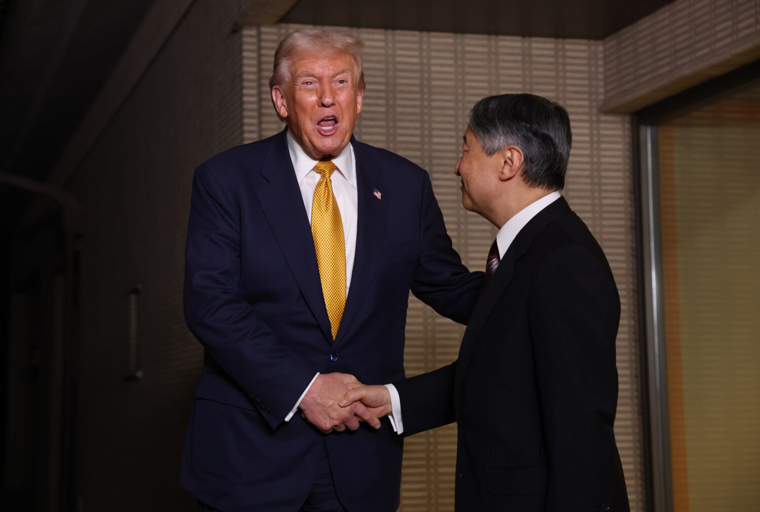 President Donald Trump, left, and Japan's Emperor Naruhito shake hands during their meeting at the ...