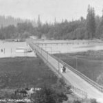 Image: The causeway of the Juanita Bridge in Lake Washington is visible to the right of the bridge in this circa 1910 image. 