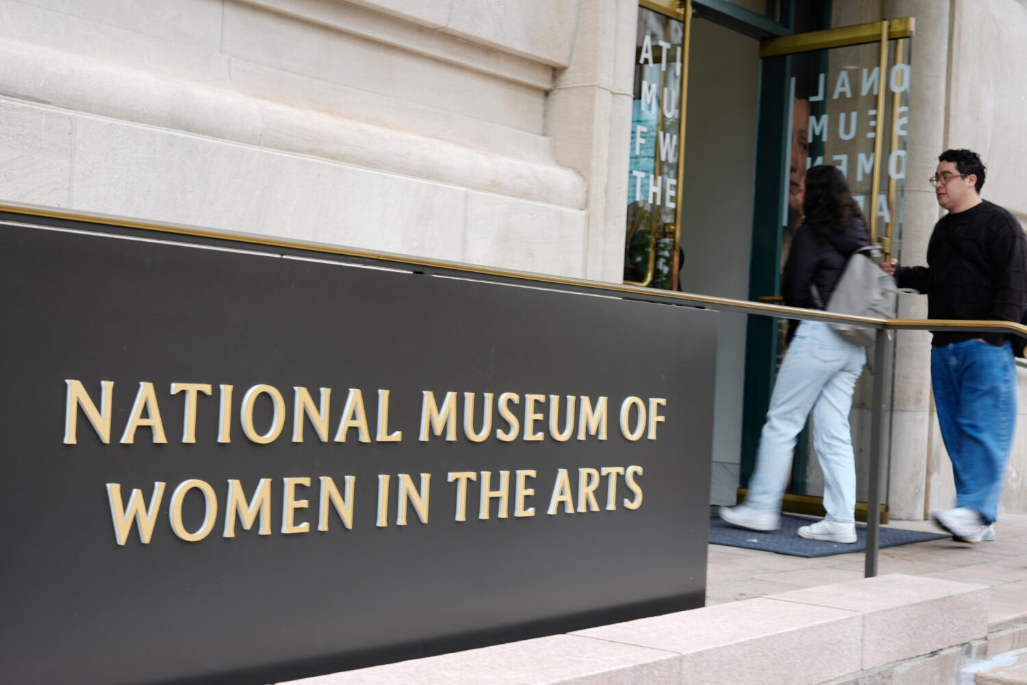 People are seen entering the main entrance to the National Museum of Women in the Arts in downtown ...