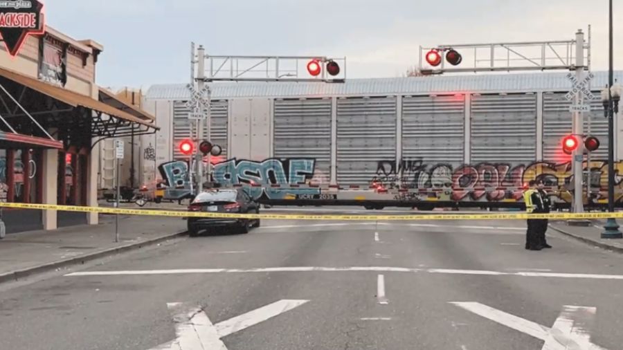 Police investigate the scene after a train struck and killed a woman in downtown Puyallup early Sat...