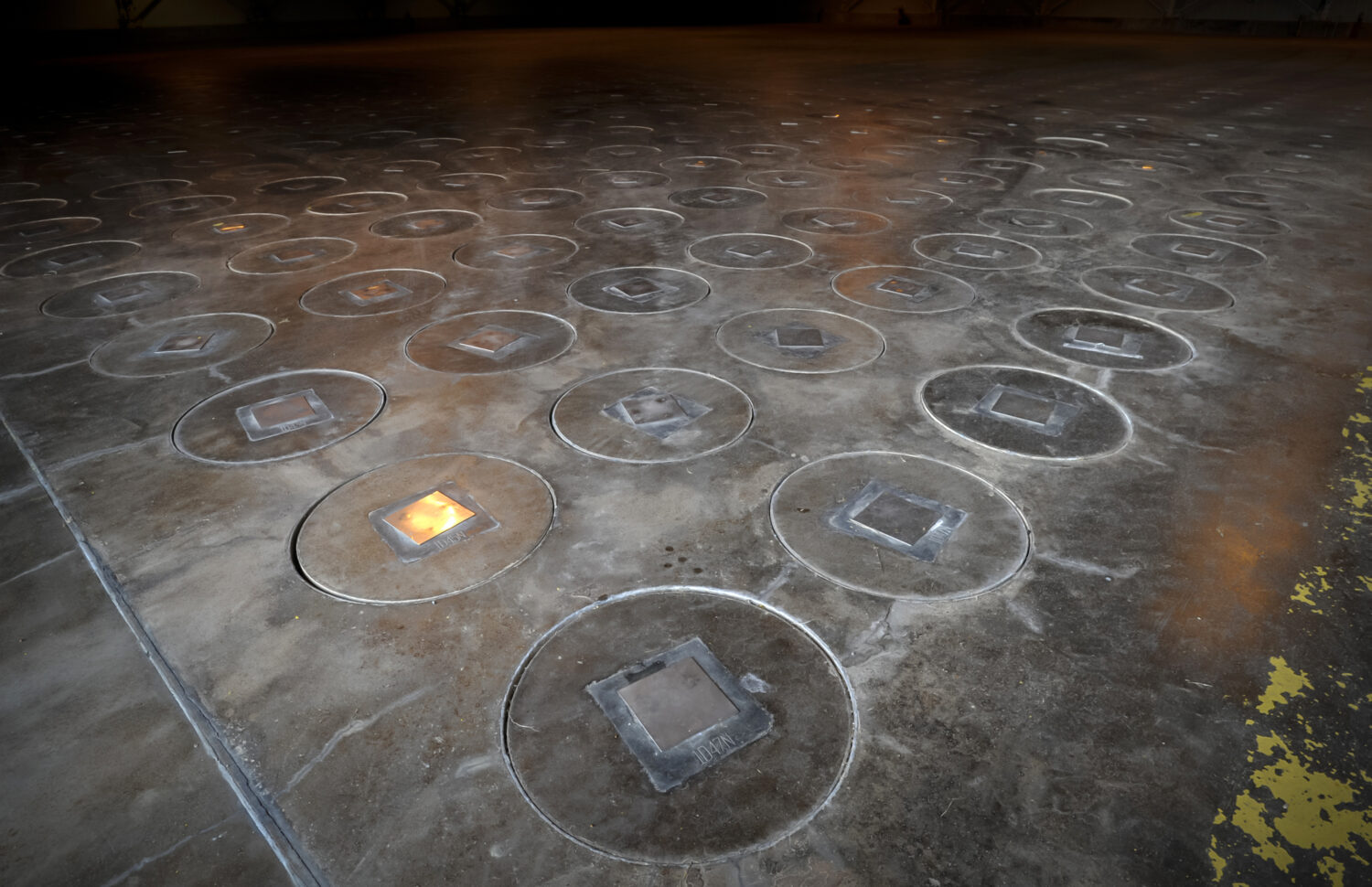 FILE - Radioactive waste sealed in large stainless steel canisters is stored under five feet of con...