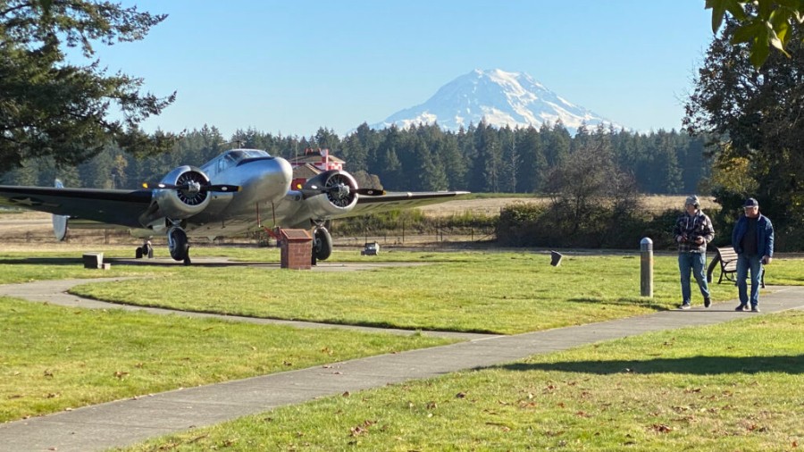 Image: Greg Barrowman, right, and producer Aaron Mason visit the display of vintage aircraft at McChord Field, part of Joint Base Lewis-McChord; Flight 293 departed from McChord on June 3, 1963.