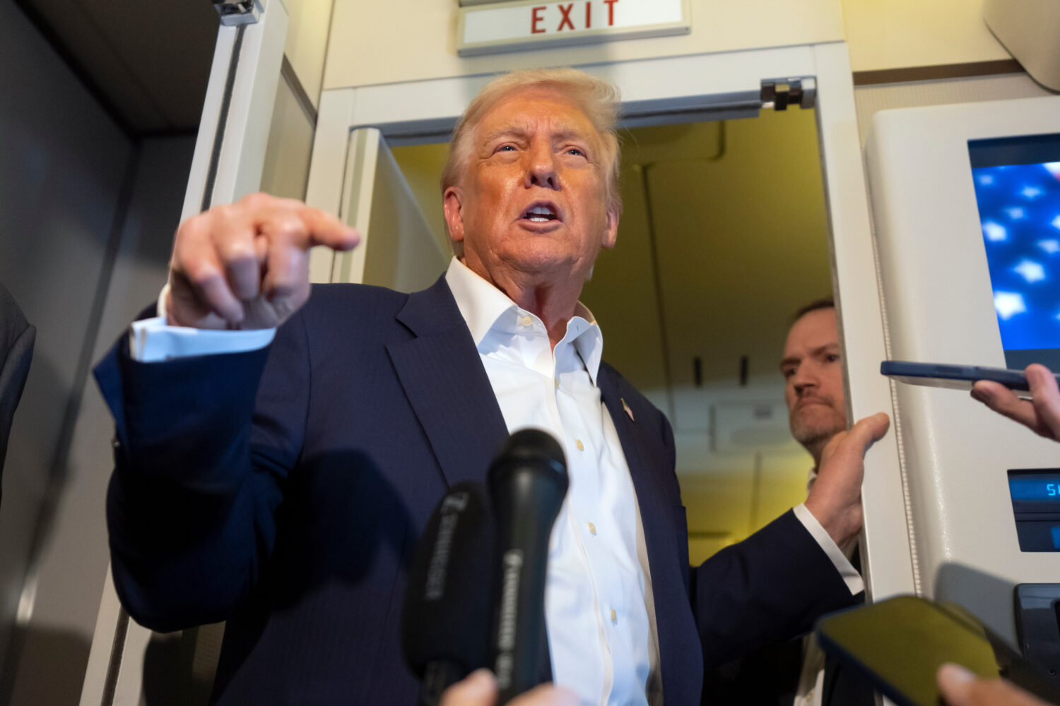 President Donald Trump speaks to reporters aboard Air Force One while traveling from Kuala Lumpur, ...