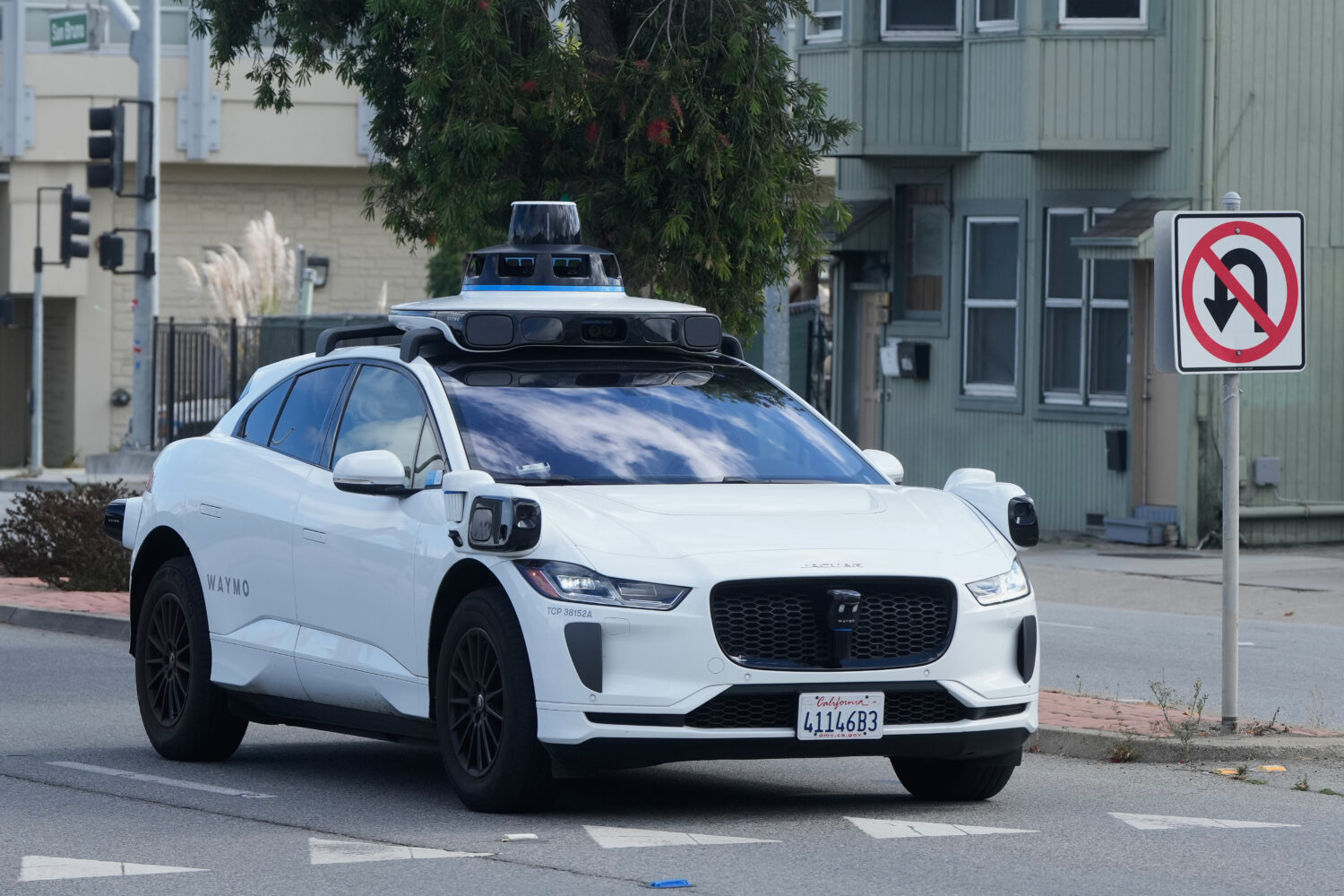 A Waymo vehicle drives past a No U-Turn sign in San Bruno, Calif., Tuesday, Sept. 30, 2025. (AP Pho...